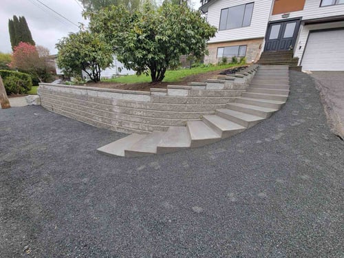 Elegant concrete steps leading up a retaining wall by Back 40 Landscaping in Abbotsford, BC