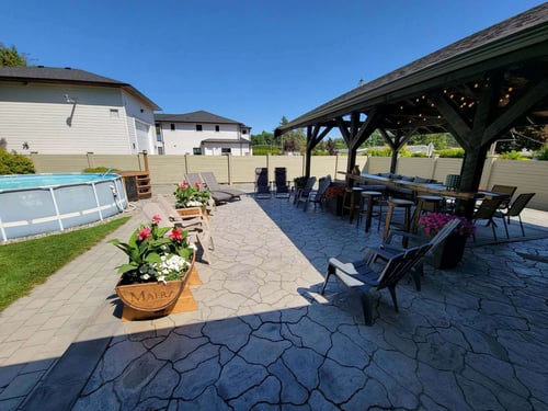 Shaded retaining wall with textured stone design by Back 40 Landscaping in Abbotsford, BC