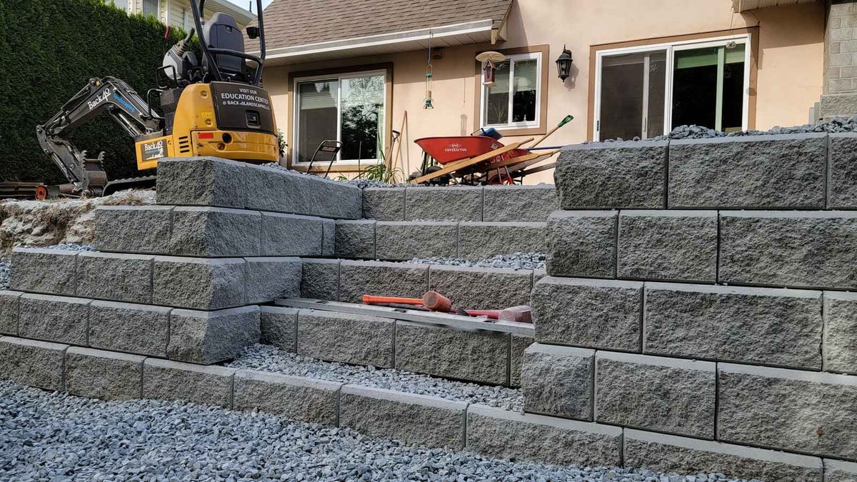 10_Completed retaining wall with gravel and steps in a residential yard in Abbotsford, BC, by Back40 Landscaping