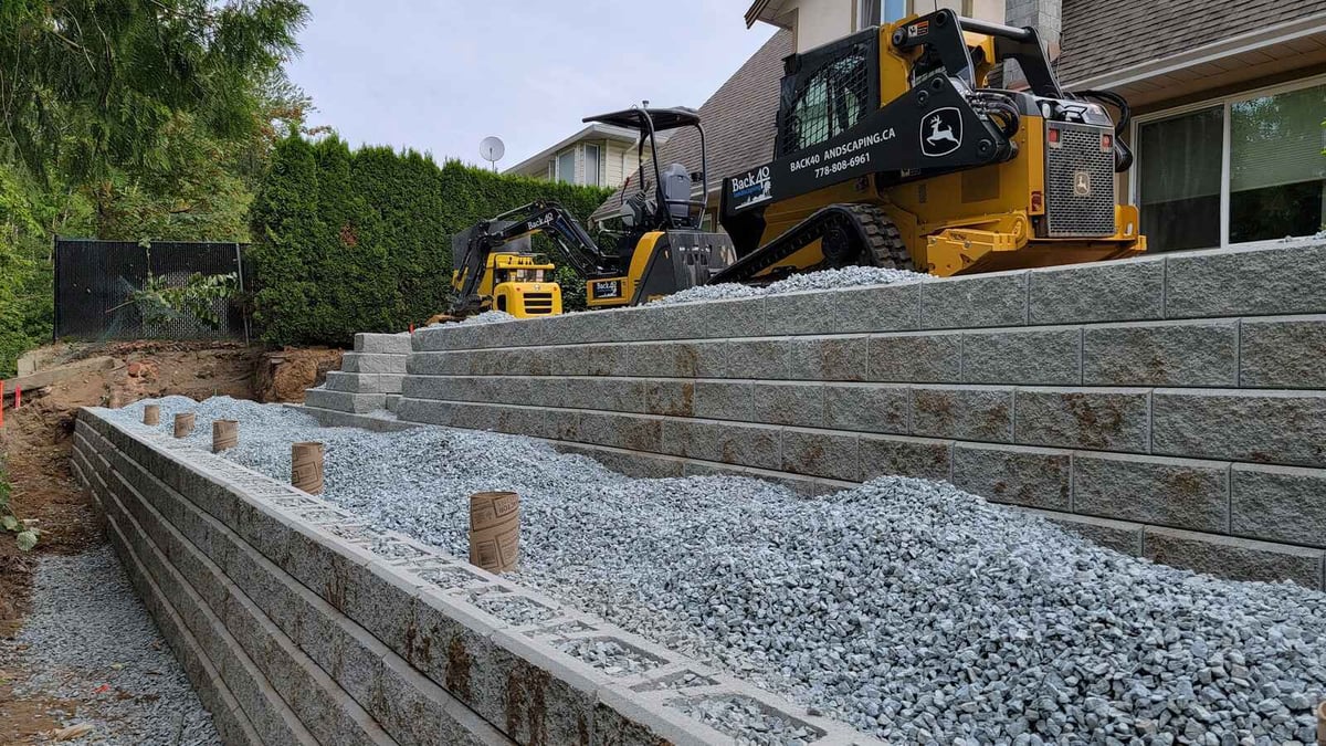 11_Multi-tier retaining wall with gravel base and construction equipment by Back40 Landscaping in Abbotsford, BC