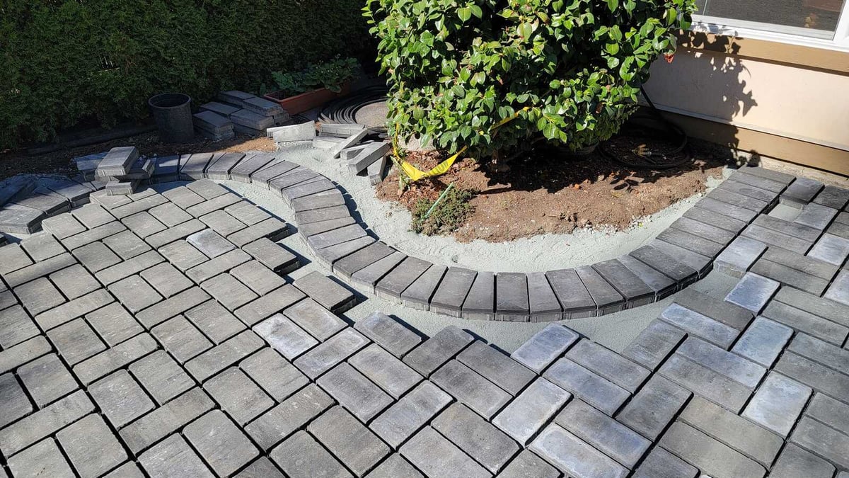 15_Close-up of curved paver installation for a backyard patio by Back40 Landscaping in Abbotsford, BC