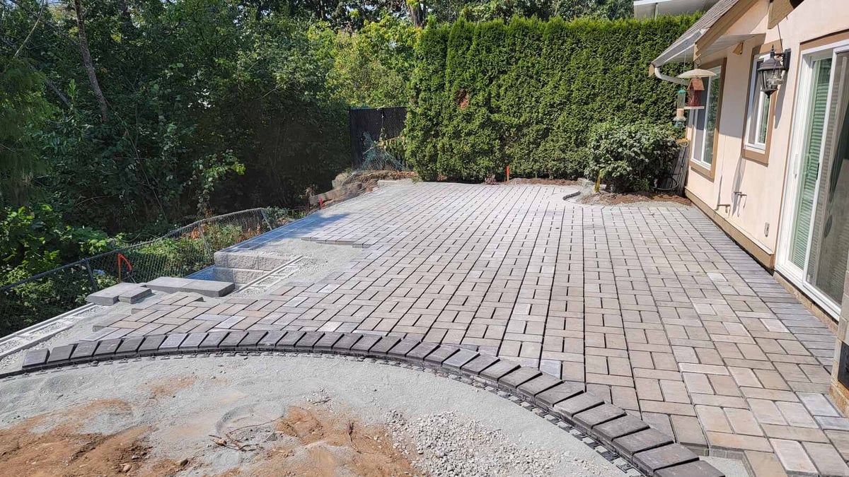 16_Nearly completed paver patio with intricate design and landscaped edges by Back40 Landscaping in Abbotsford, BC