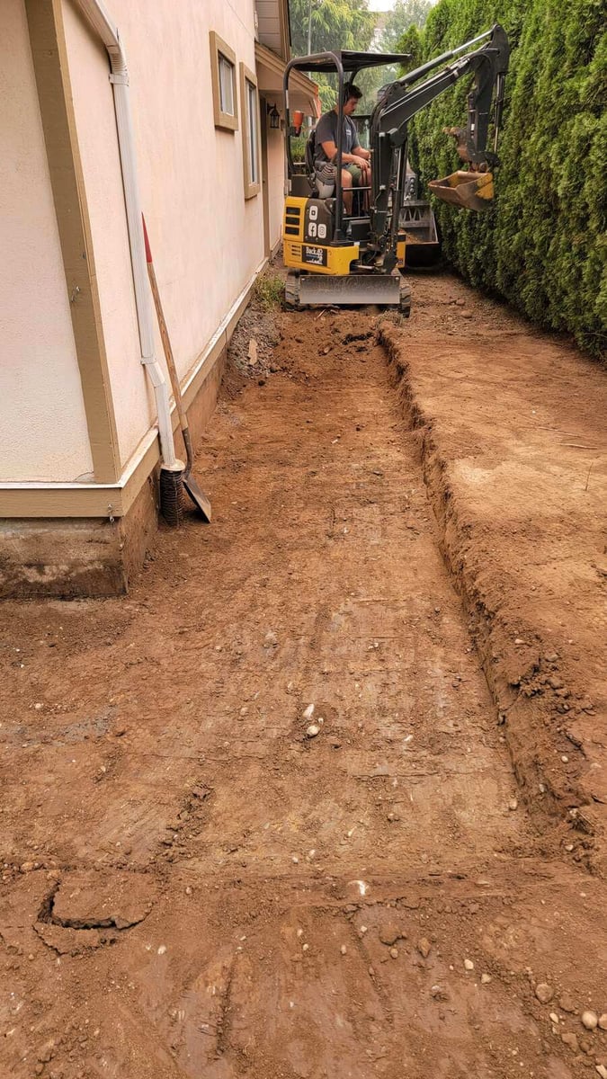 18_Excavator digging a side yard trench for landscaping improvements by Back40 Landscaping in Abbotsford, BC