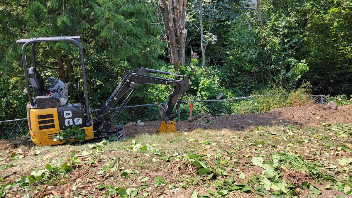 3_Compact excavator clearing soil for a landscaping project by Back40 Landscaping in Abbotsford, BC