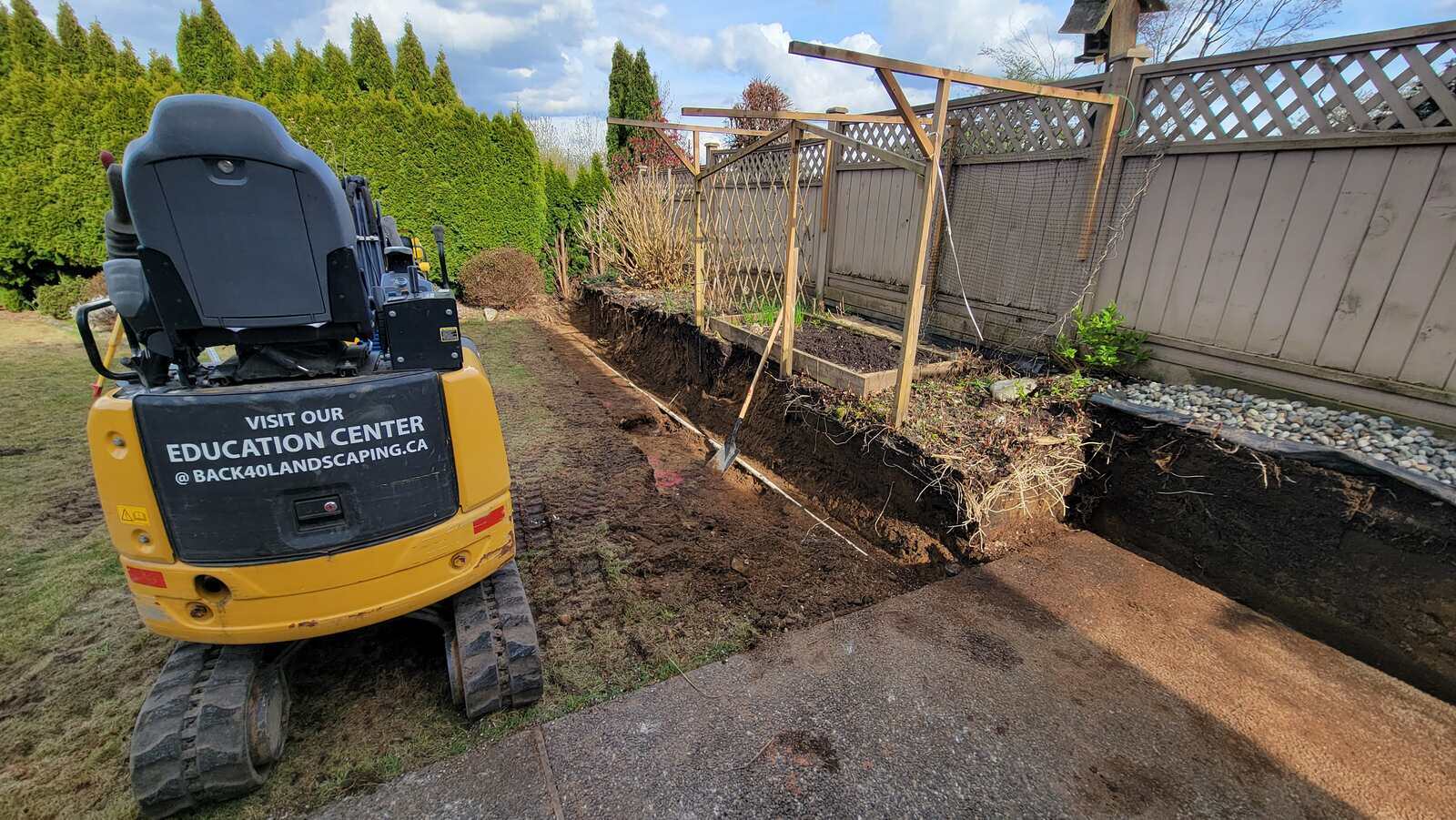 3_retaining-wall-project-back40-landscaping-burnaby-bc-excavation-process-begins-with-digging-along-backyard