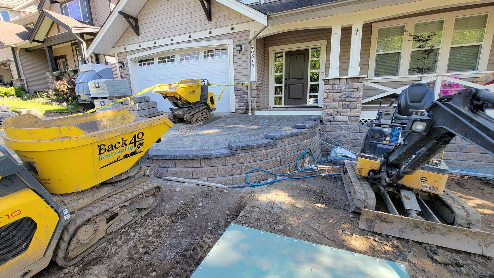 Construction equipment on-site for retaining wall project by Back 40 Landscaping, Chilliwack, BC