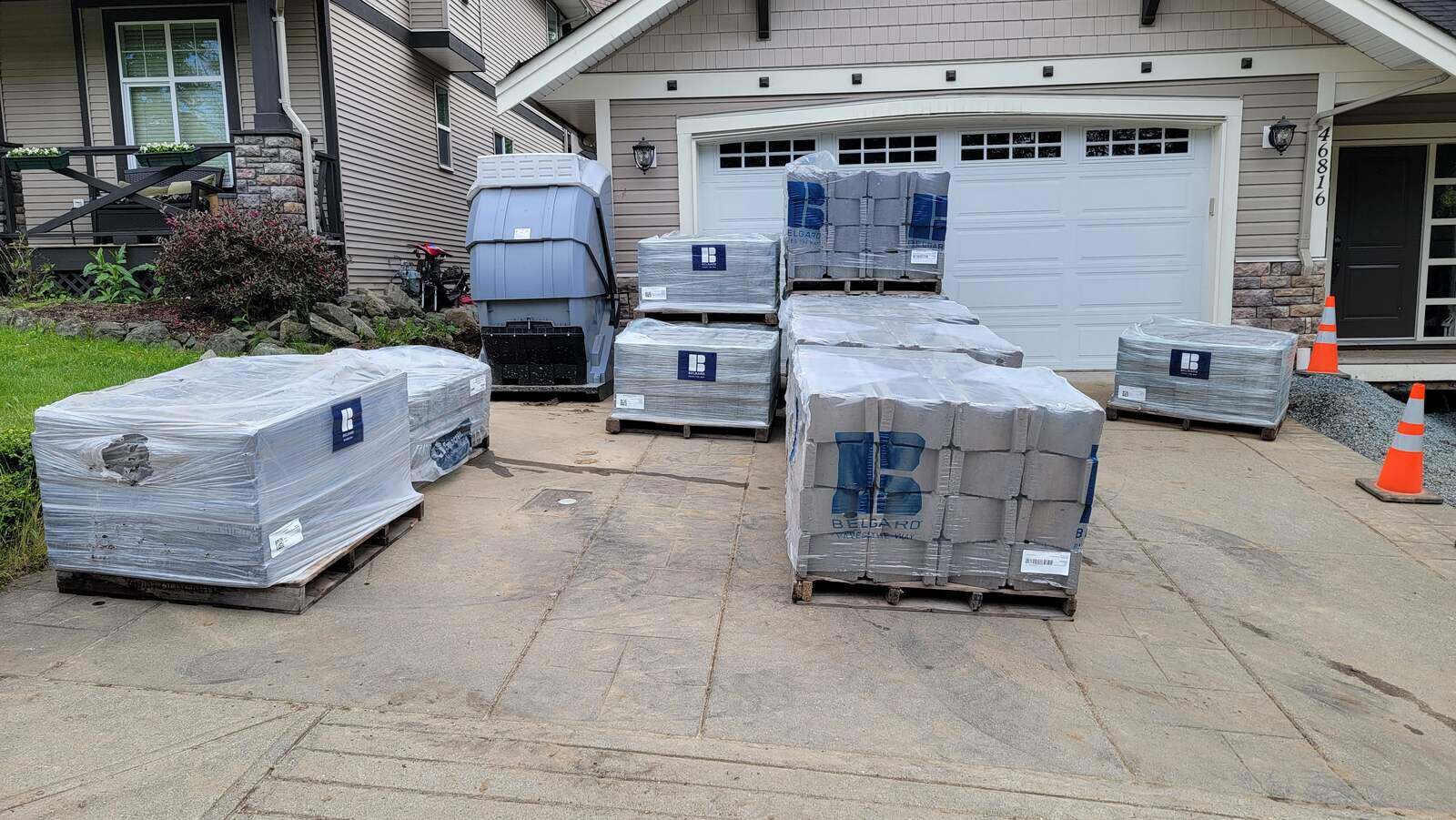 2_pallets-of-hardscape-materials-on-driveway-before-installation-by-back40-landscaping-in-chilliwack