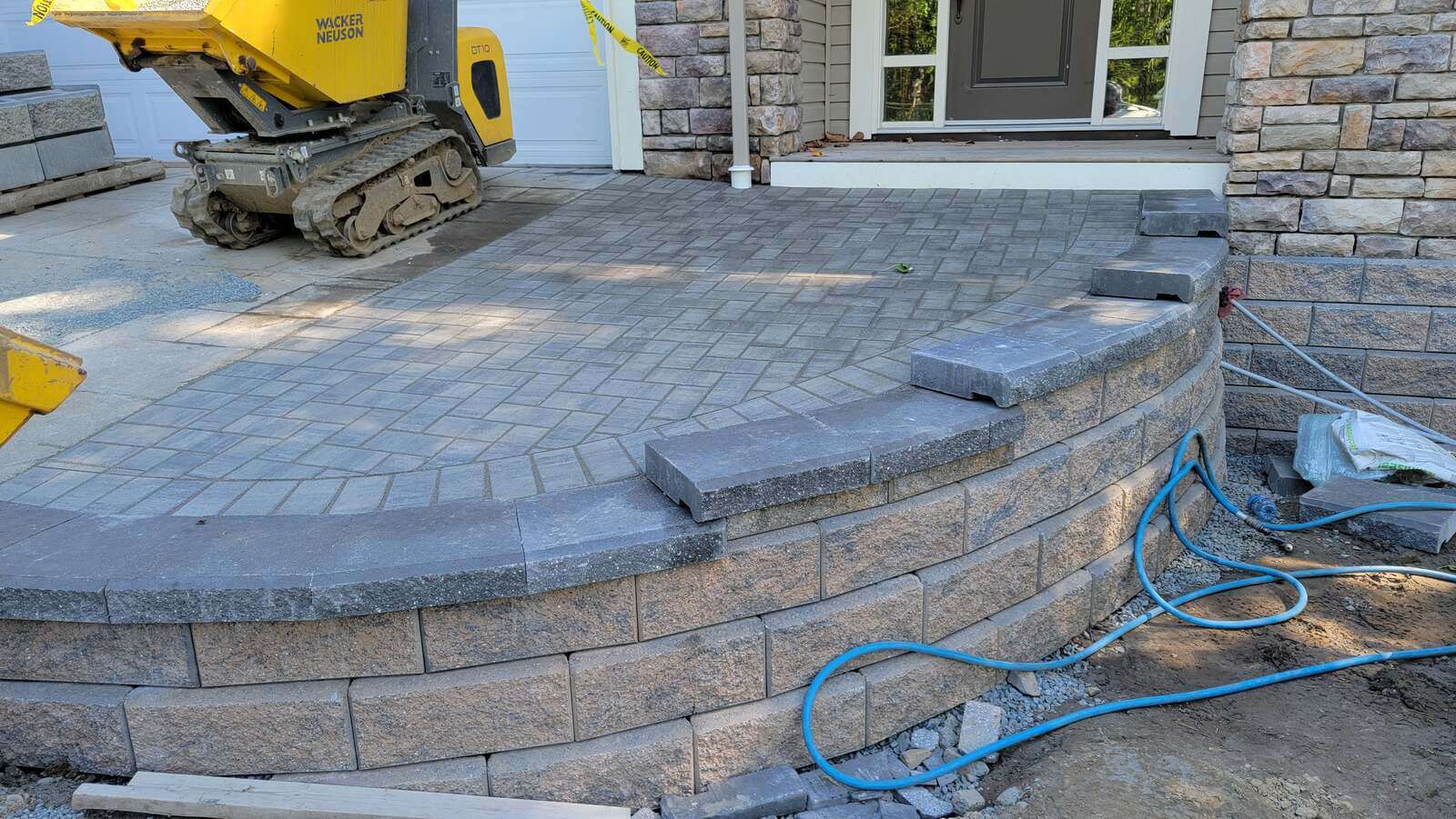 5_close-up-of-curved-stone-retaining-wall-and-paver-patio-in-progress-in-chilliwack