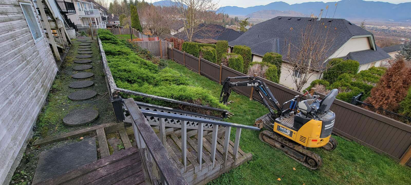 10_complete-view-of-backyard-with-new-retaining-wall-and-excavation-equipment-in-chilliwack-bc