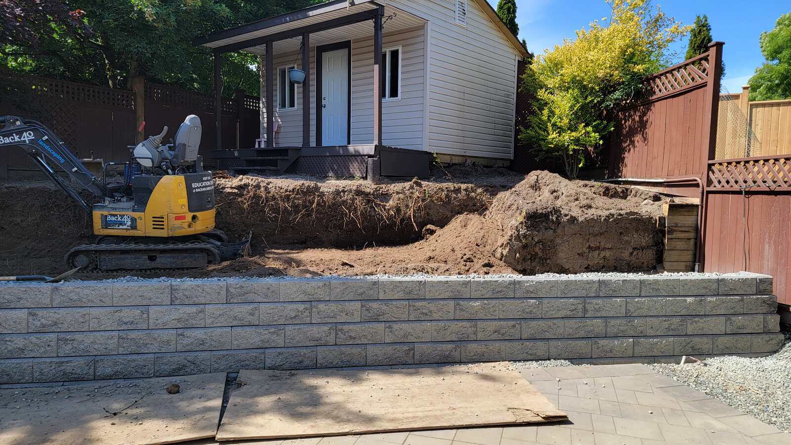 12_Retaining wall construction underway by Back40 Landscaping in Mission, BC, with compact excavator