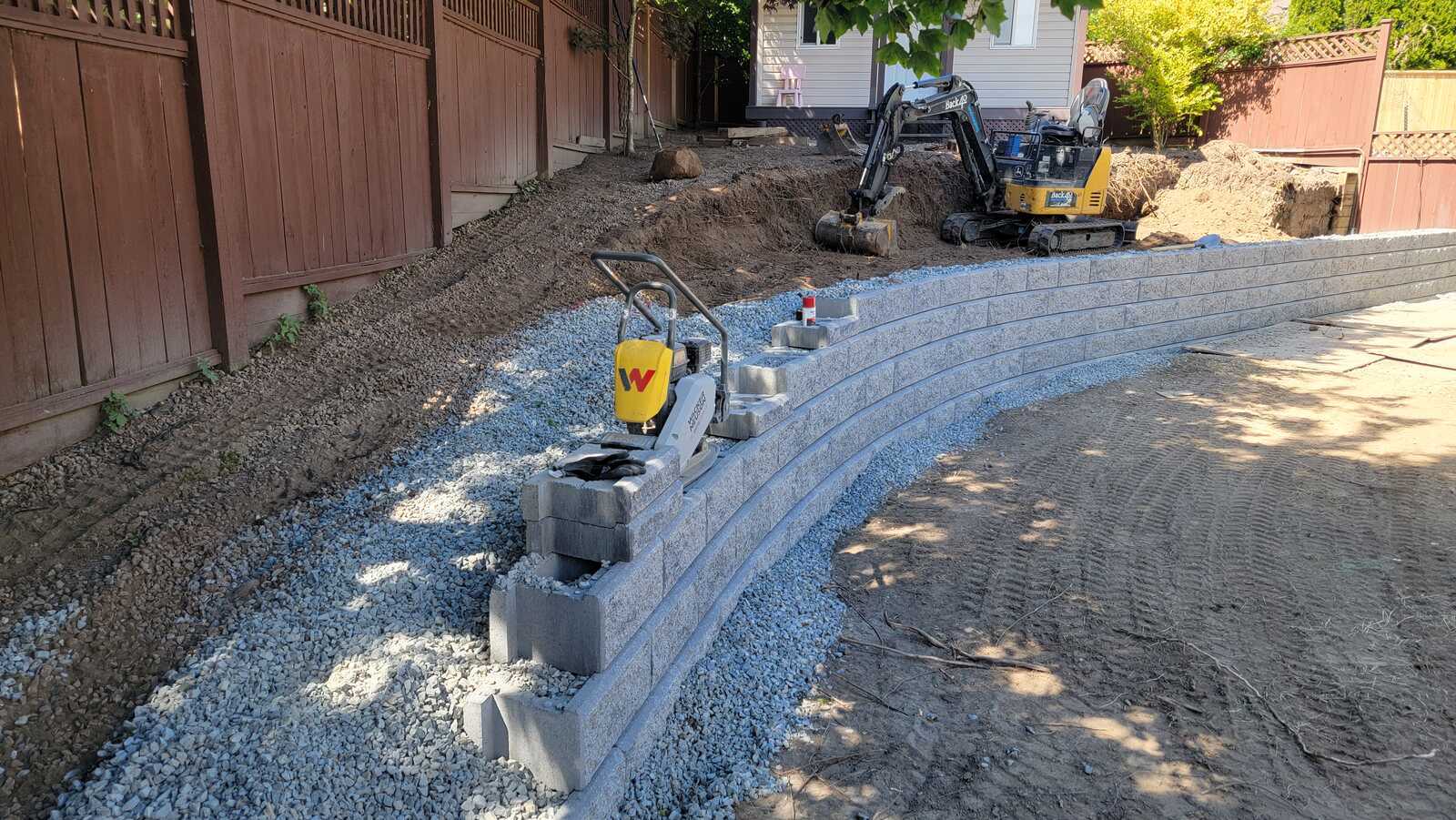 13_Curved retaining wall installation in progress by Back40 Landscaping, Mission, BC