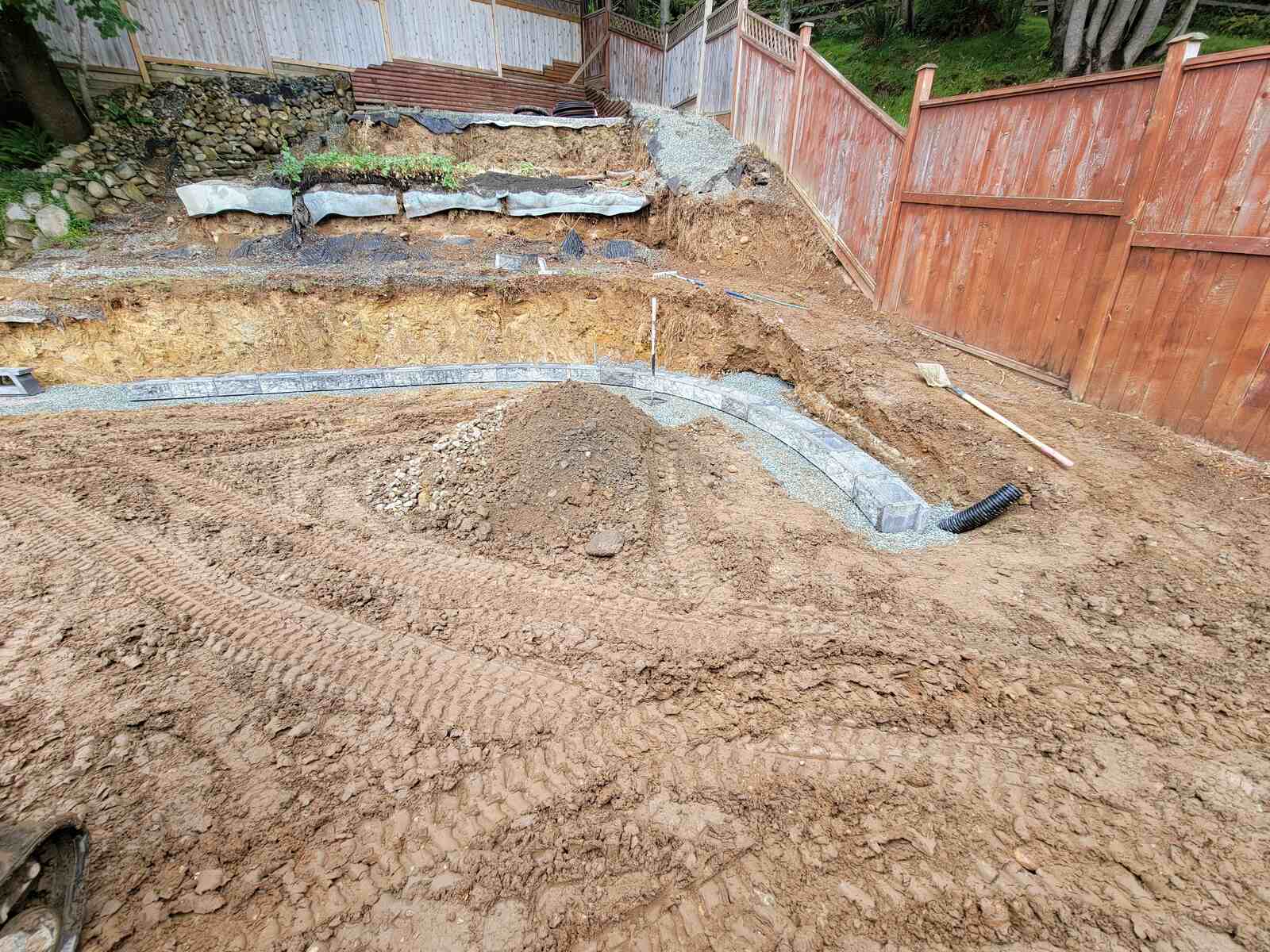 12_Foundation layer of retaining wall with gravel and blocks, built by Back40 Landscaping in Mission, BC
