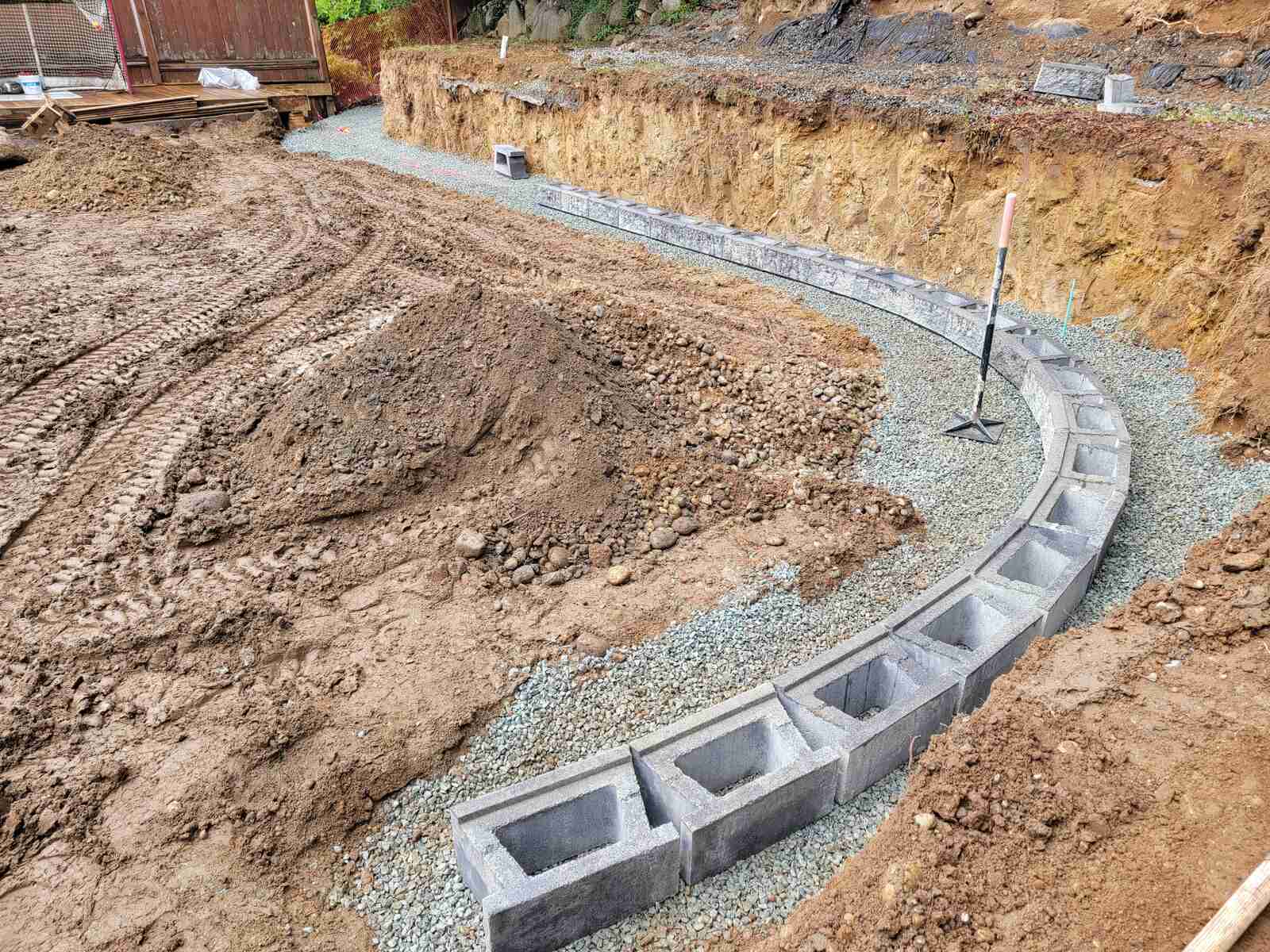 13_Progress on a tiered retaining wall with visible excavation and block placement by Back40 Landscaping in Mission, BC