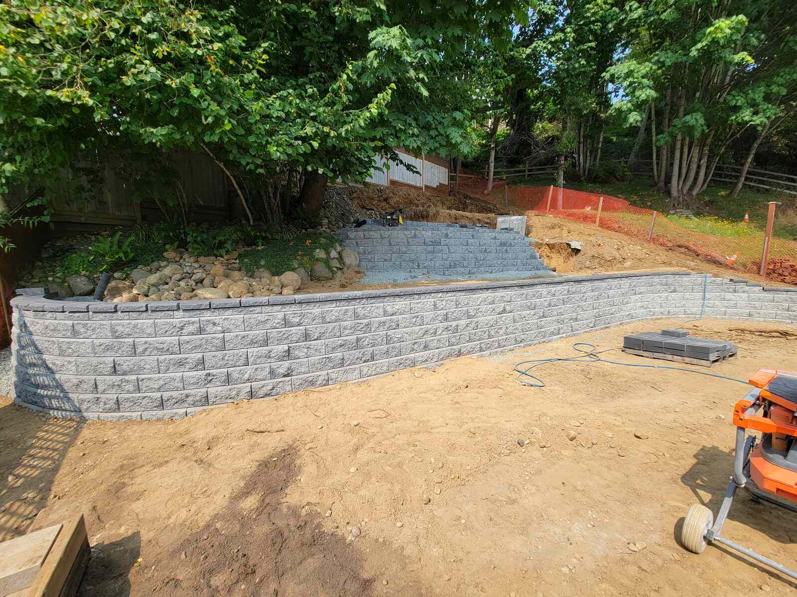 18_Detailed view of retaining wall progression with tiered block design by Back40 Landscaping in Mission, BC