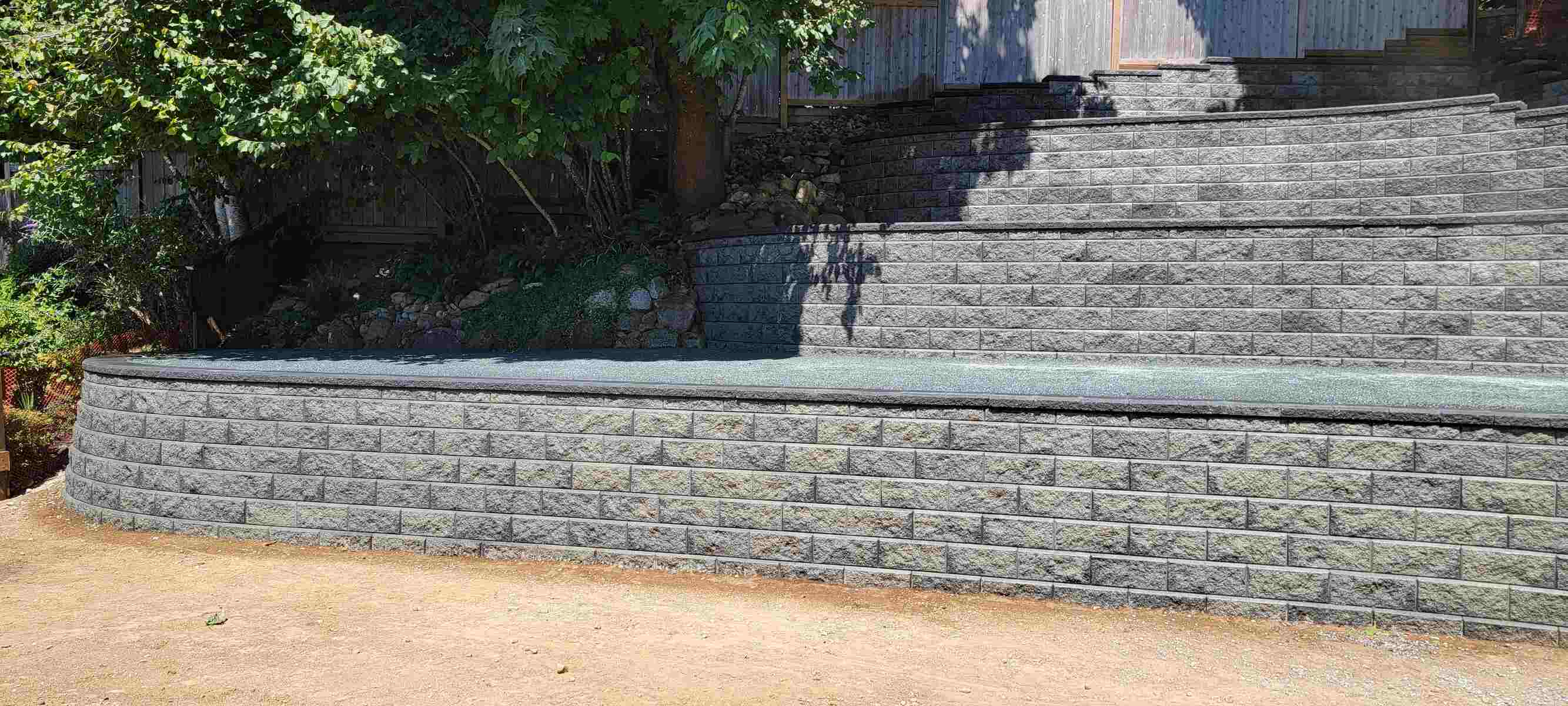 24_Completed four-tier retaining wall with landscaping details by Back40 Landscaping in Mission, BC