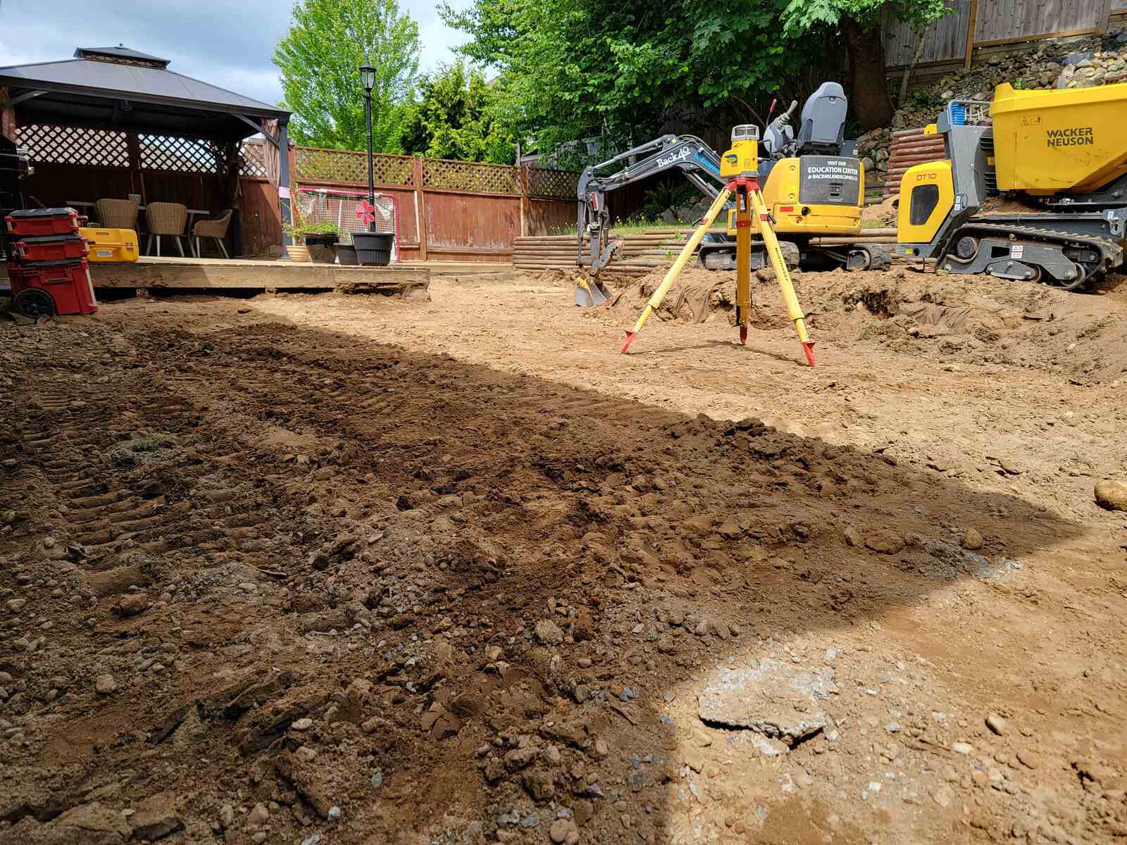 5_Four-tiered retaining wall construction by Back40 Landscaping in Mission, BC, showing leveling equipment and machinery