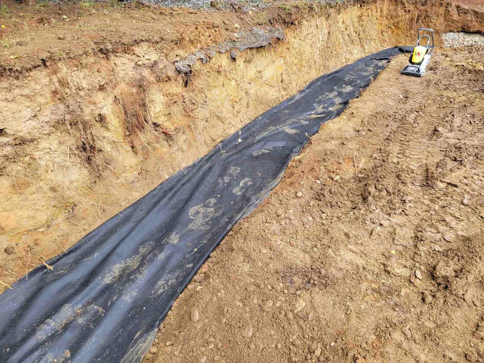 9_Geotextile fabric laid for retaining wall construction by Back40 Landscaping in Mission, BC
