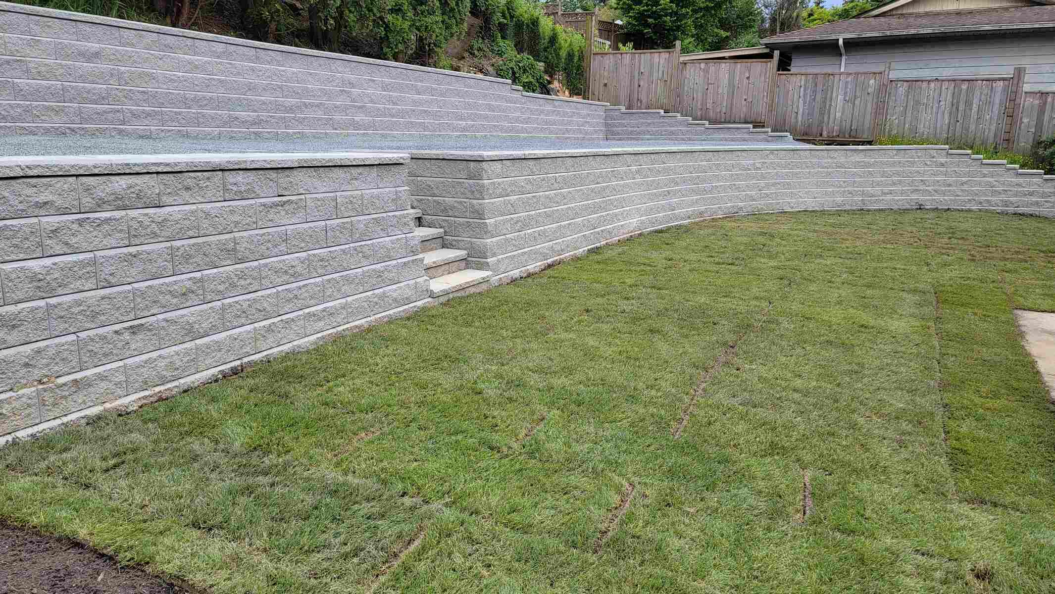 13_Freshly sodded backyard with multi-tier retaining walls built by Back40 Landscaping in Mission, BC
