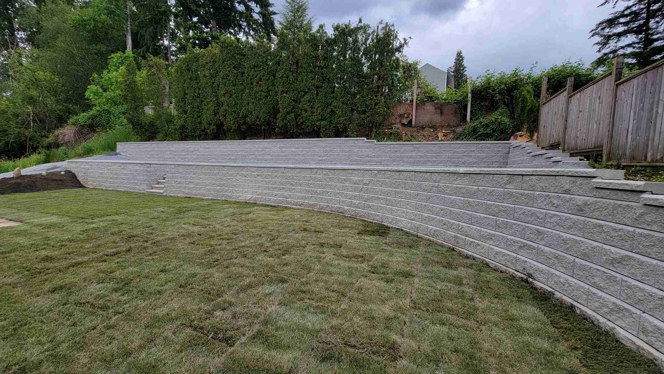 16_Tiered retaining wall with new sod in a landscaped backyard by Back40 Landscaping in Mission, BC