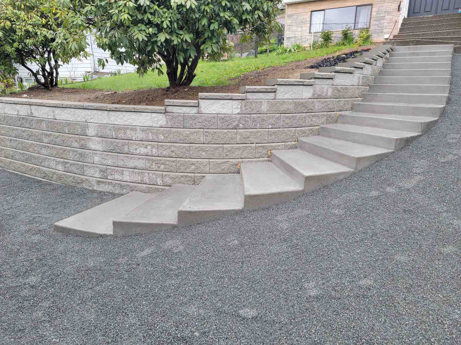 18_Curved retaining wall with stairs and gravel landscaping in Mission, BC, by Back40 Landscaping