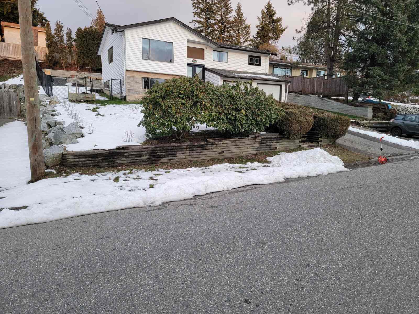 1_Retaining wall project in Mission, BC, featuring snow-covered landscaping by Back40 Landscaping