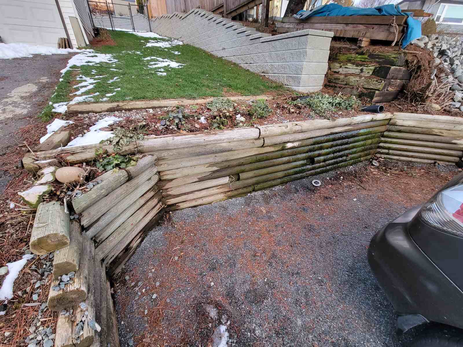 2_Close-up of a weathered retaining wall at a residential property in Mission, BC, built by Back40 Landscaping