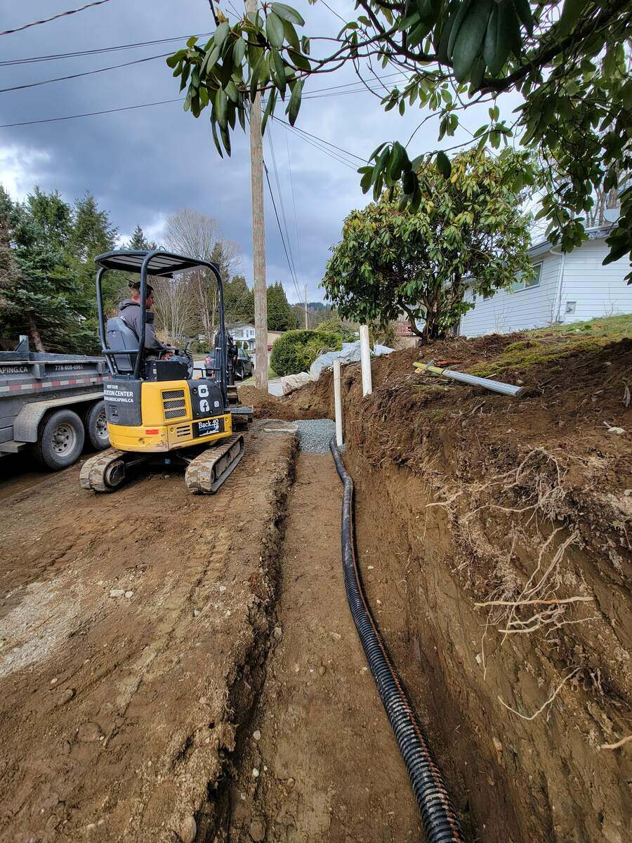 9_Excavation trench with drainage pipes being installed for a retaining wall in Mission, BC, by Back40 Landscaping