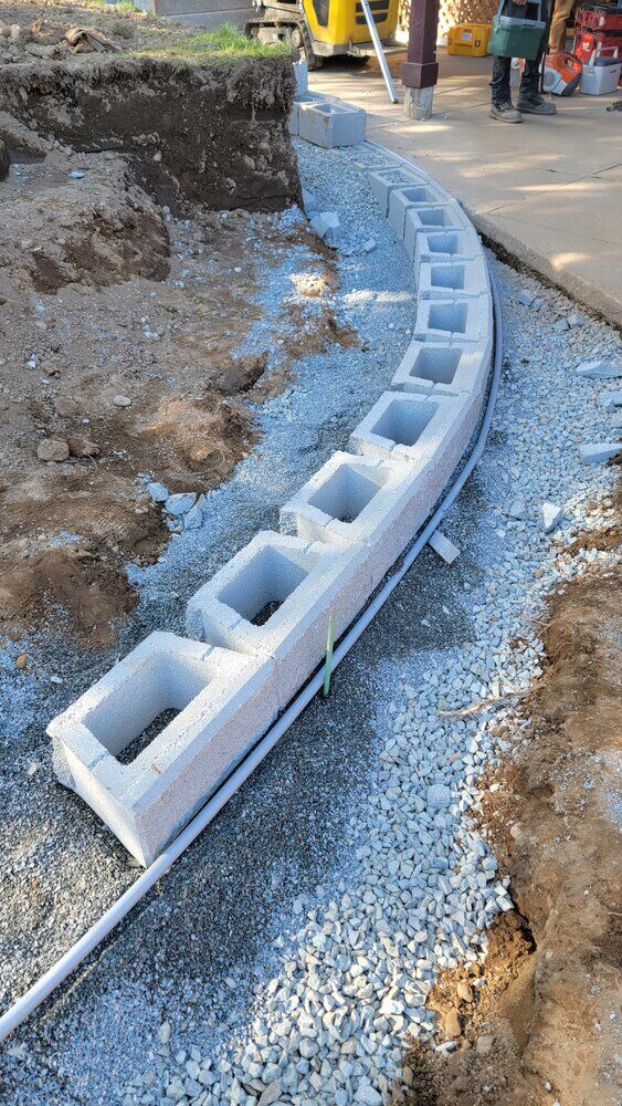 10_Completed curved retaining wall with fresh gravel base by Back40 Landscaping in Mission, BC