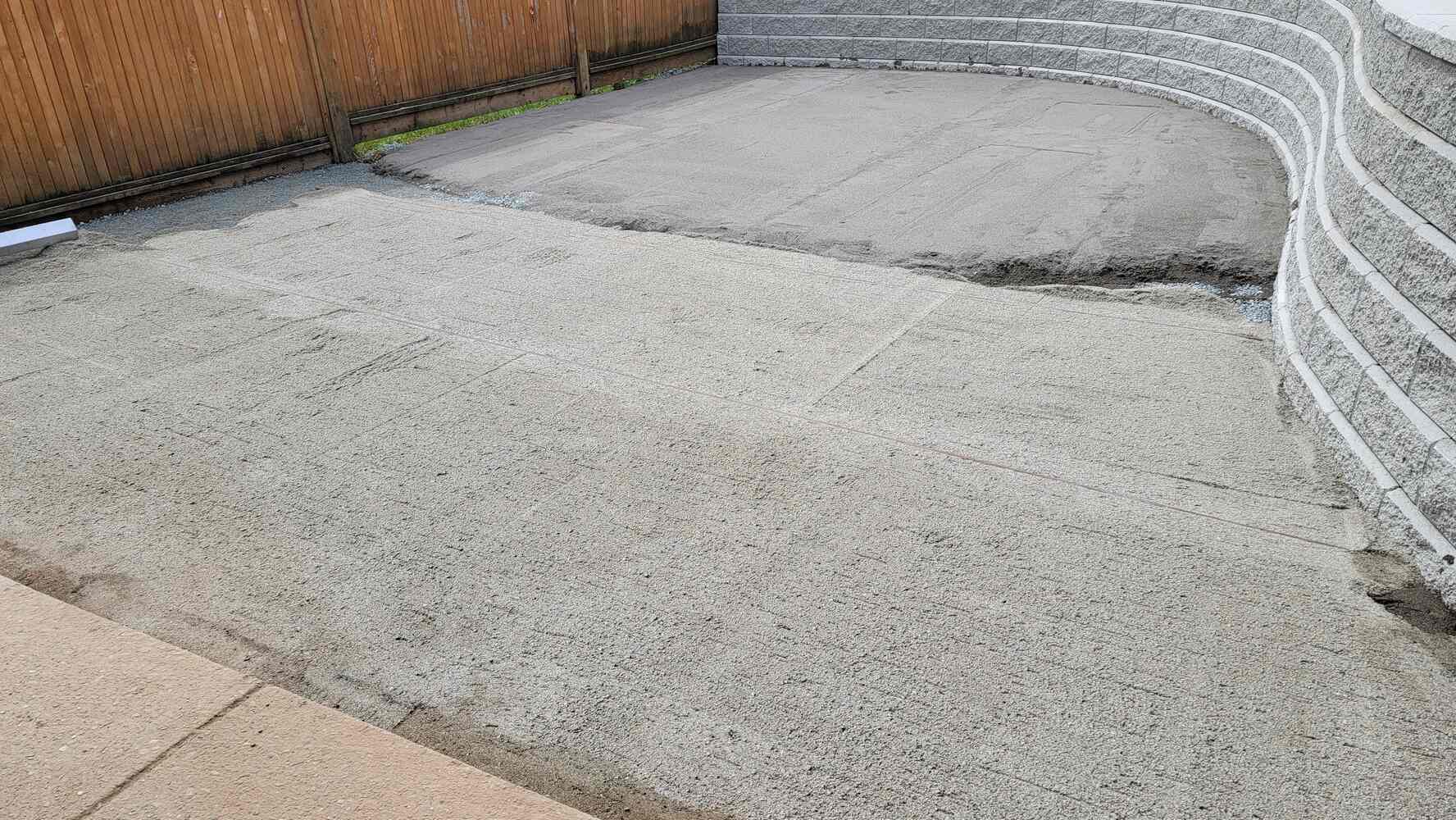 18_Workers smoothing sand for flagstone patio construction by Back40 Landscaping in Mission, BC