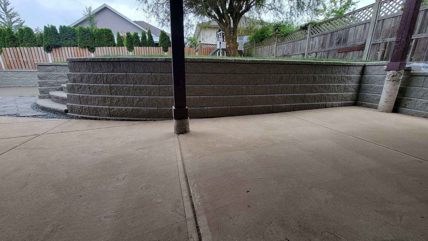 23_Curved retaining wall with steps and grass lawn by Back40 Landscaping in Mission, BC