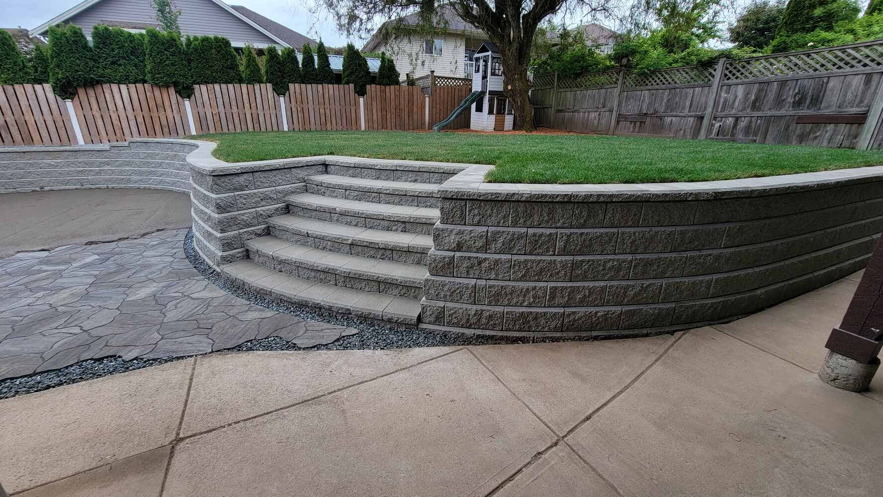 24_Stonework patio and retaining wall with grass landscaping by Back40 Landscaping in Mission, BC