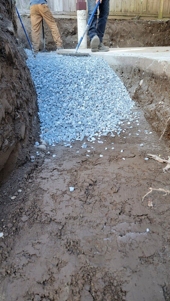 8_Workers spreading gravel for a flagstone patio base by Back40 Landscaping in Mission, BC