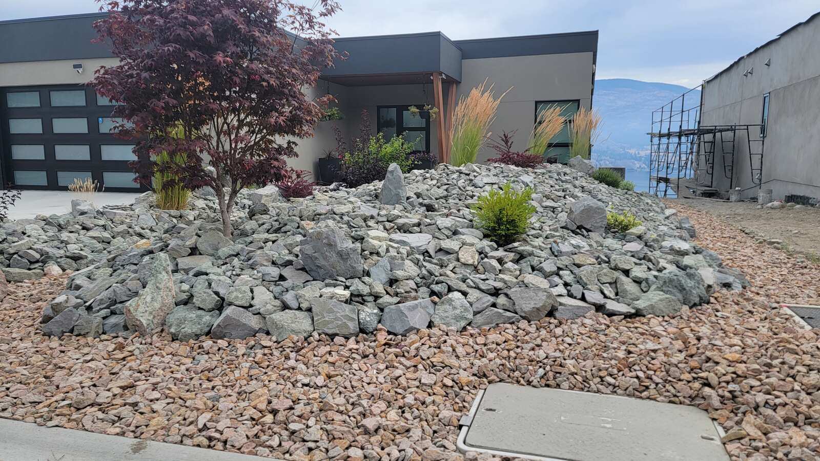 Modern rock garden in front of home landscaped by Back 40 Landscaping in Abbotsford, BC