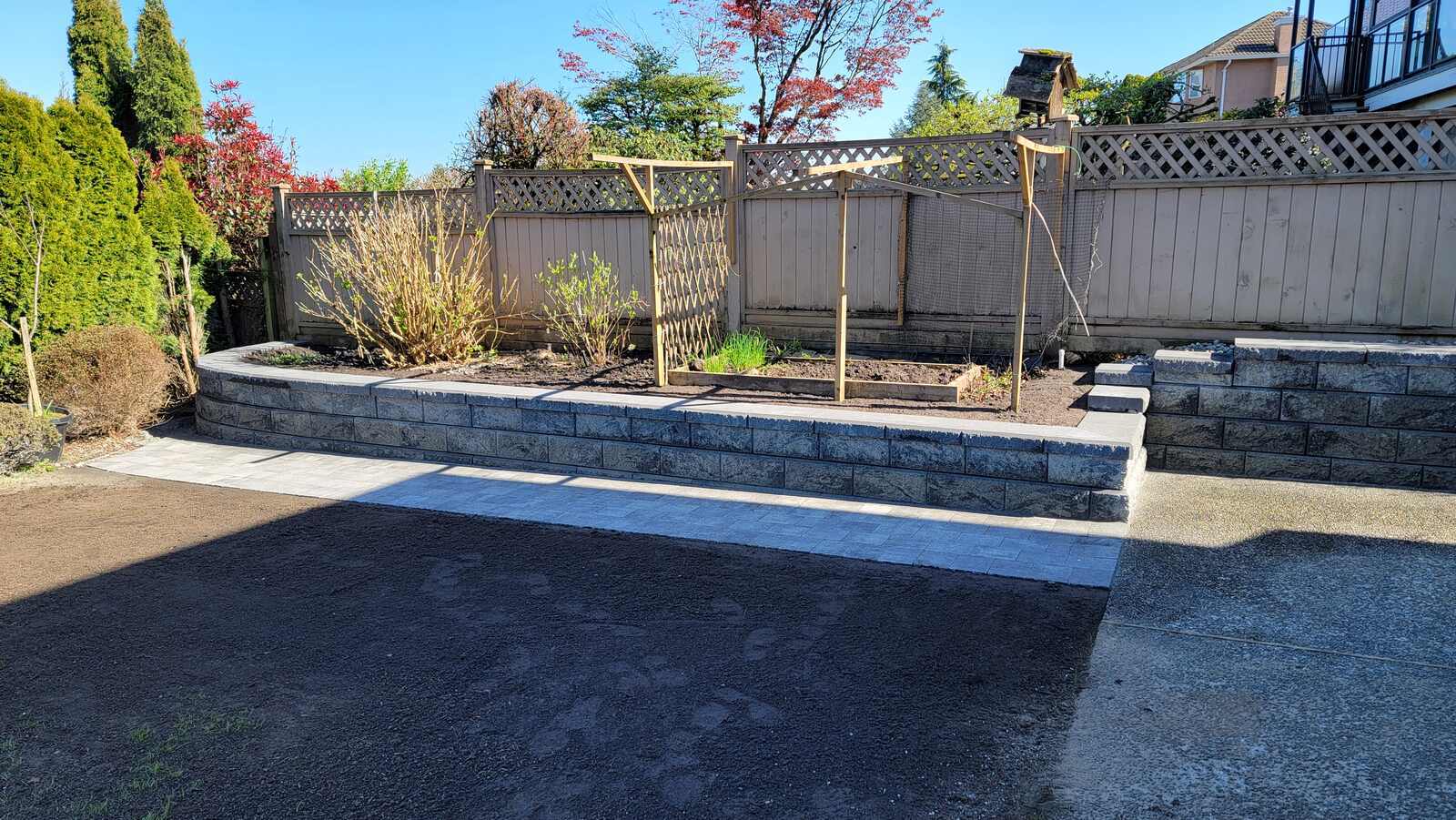 Completed garden retaining wall and soil leveling by Back 40 Landscaping in Burnaby, BC