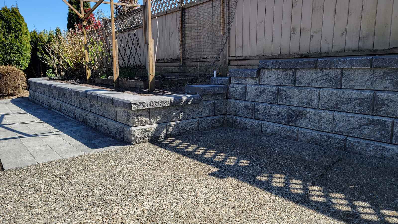 Garden space with completed retaining wall and landscaping by Back 40 Landscaping in Burnaby, BC