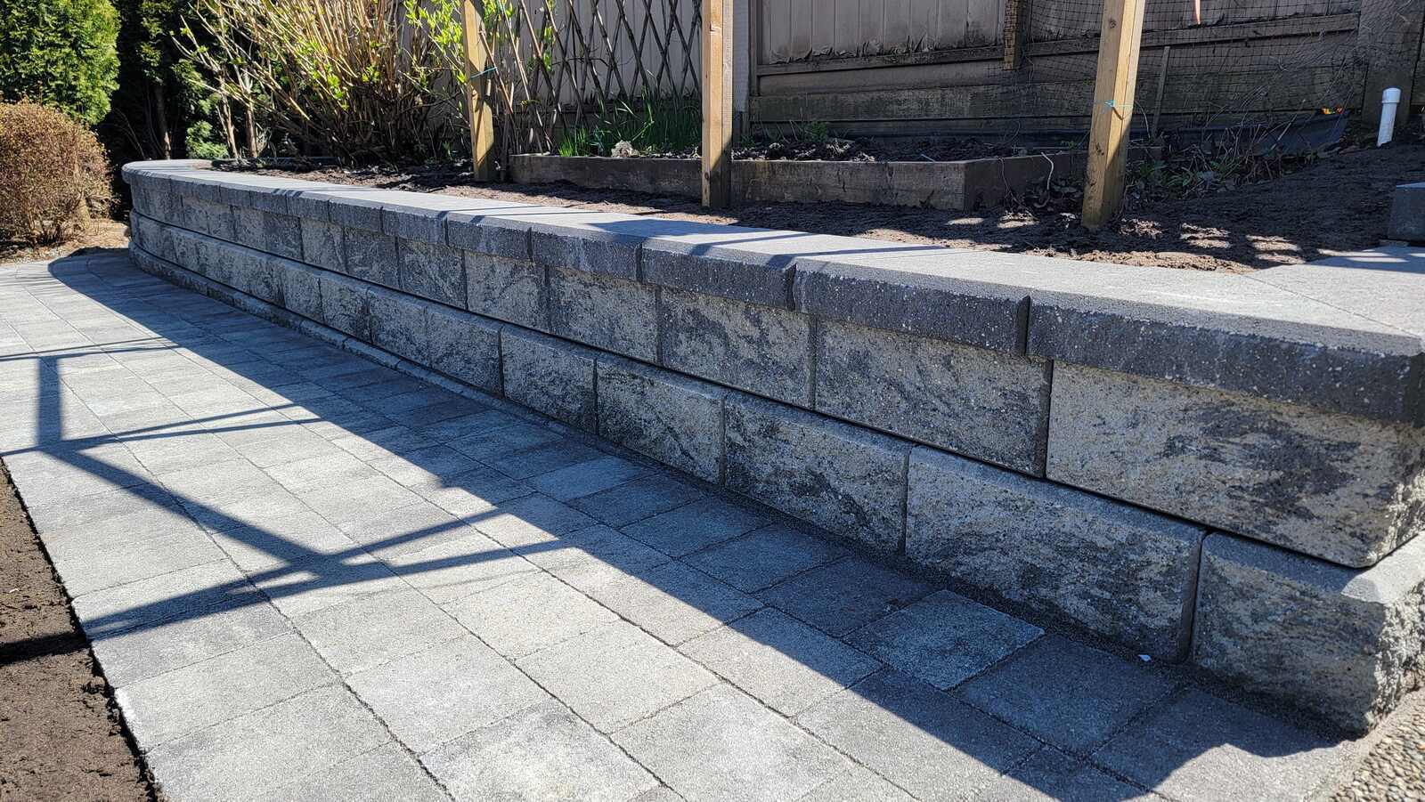 Newly installed garden retaining wall and landscaped area by Back 40 Landscaping in Burnaby, BC