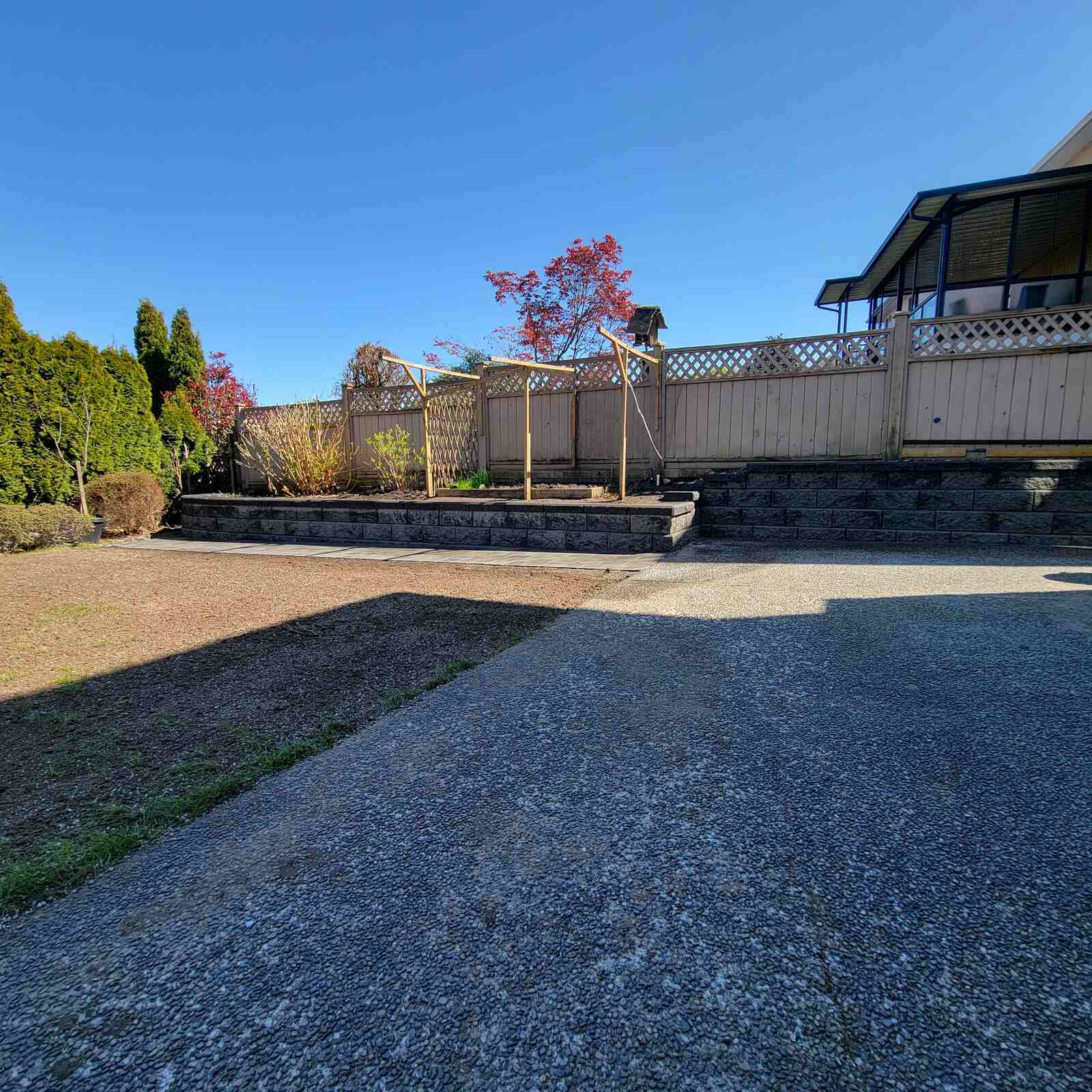 Newly installed retaining wall and pathway in landscaped garden by Back 40 Landscaping in Burnaby, BC