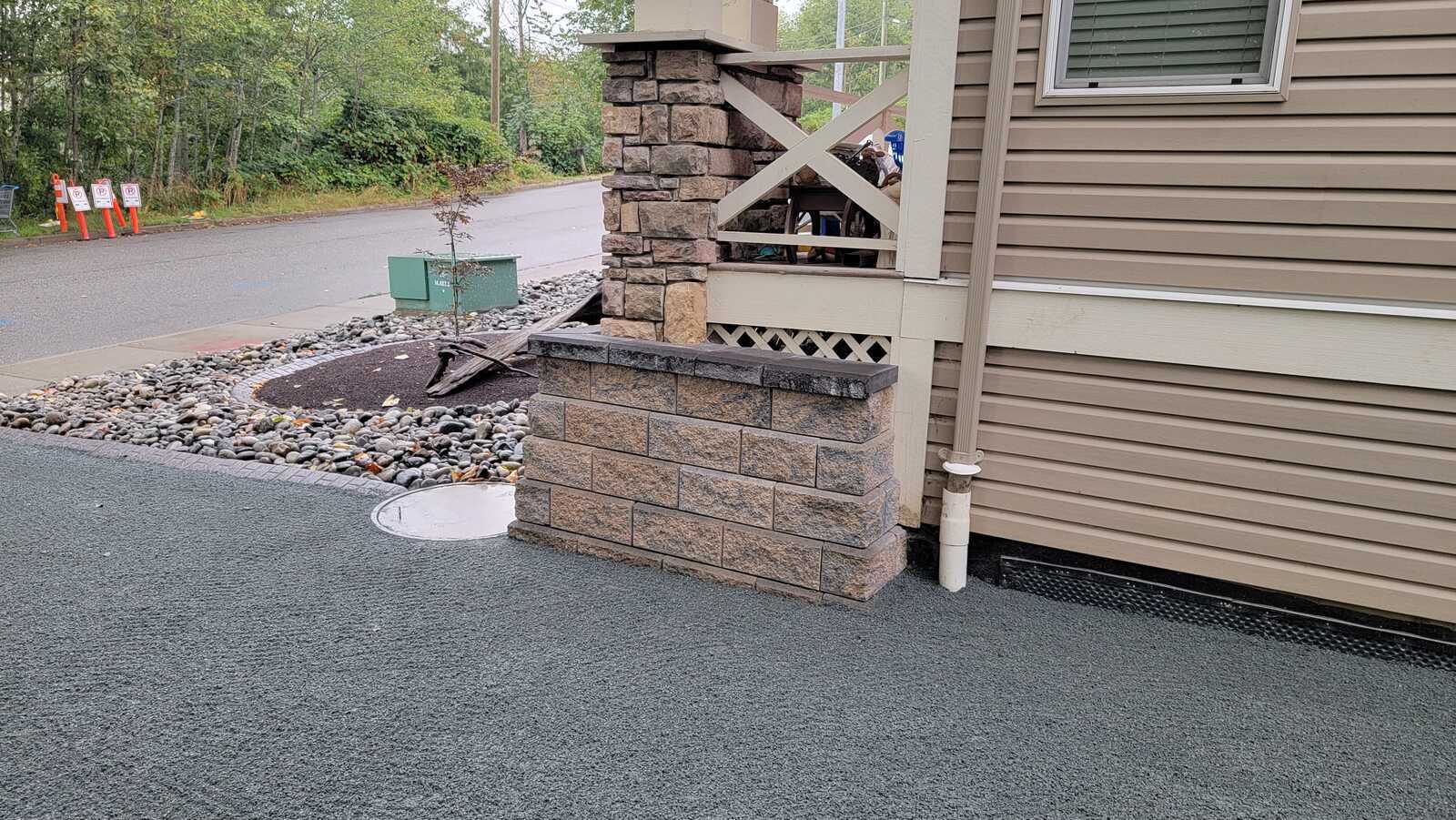 Landscaping detail with stone retaining feature near front porch by Back 40 Landscaping, Chilliwack, BC