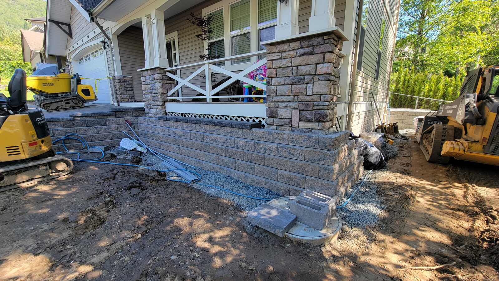 Side view of porch with retaining wall construction by Back 40 Landscaping in Chilliwack, BC