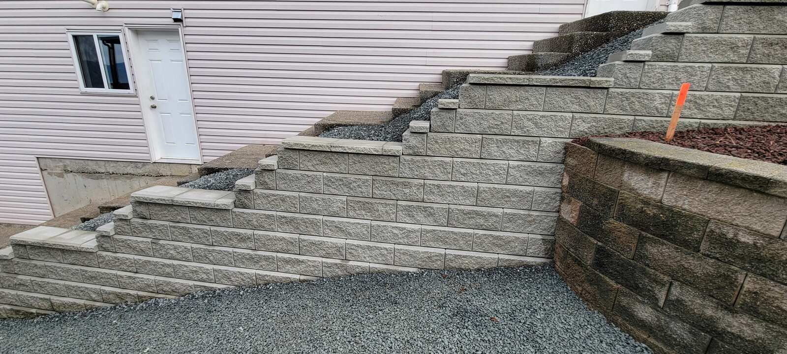 Residential retaining wall landscaping with fresh soil, installed by Back 40 Landscaping, Chilliwack, BC