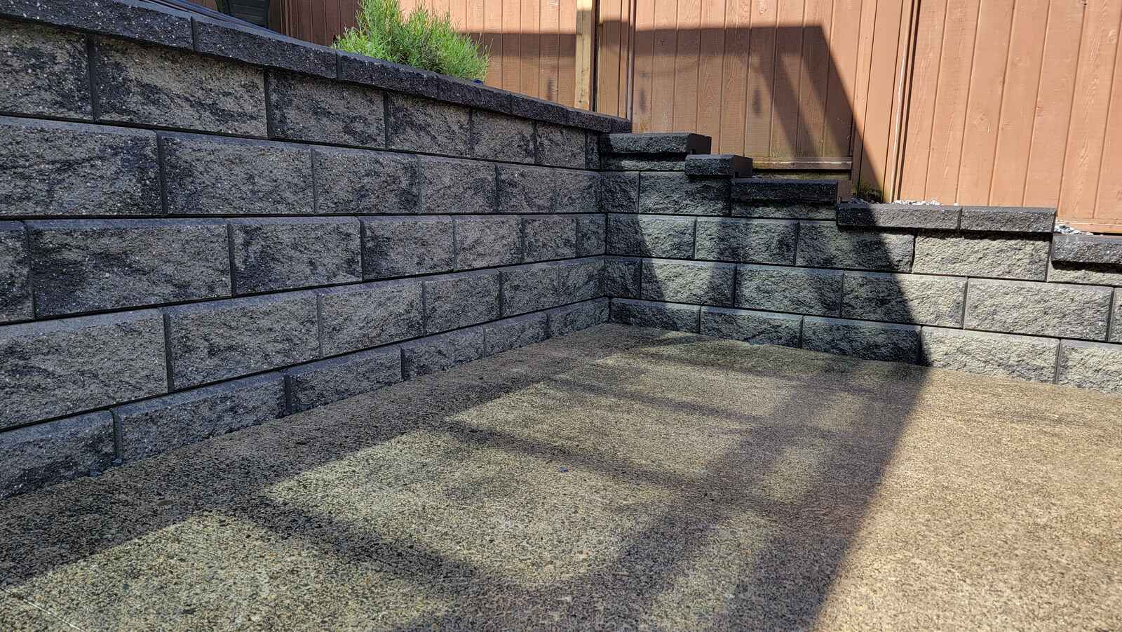 Langley backyard retaining wall featuring block pattern by Back 40 Landscaping