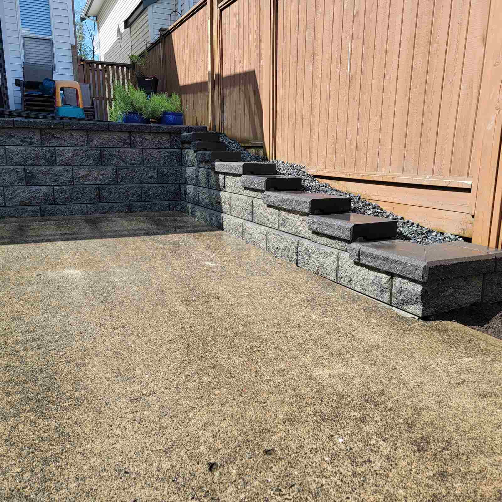 Retaining wall with steps providing easy access, built by Back 40 Landscaping in Langley, BC