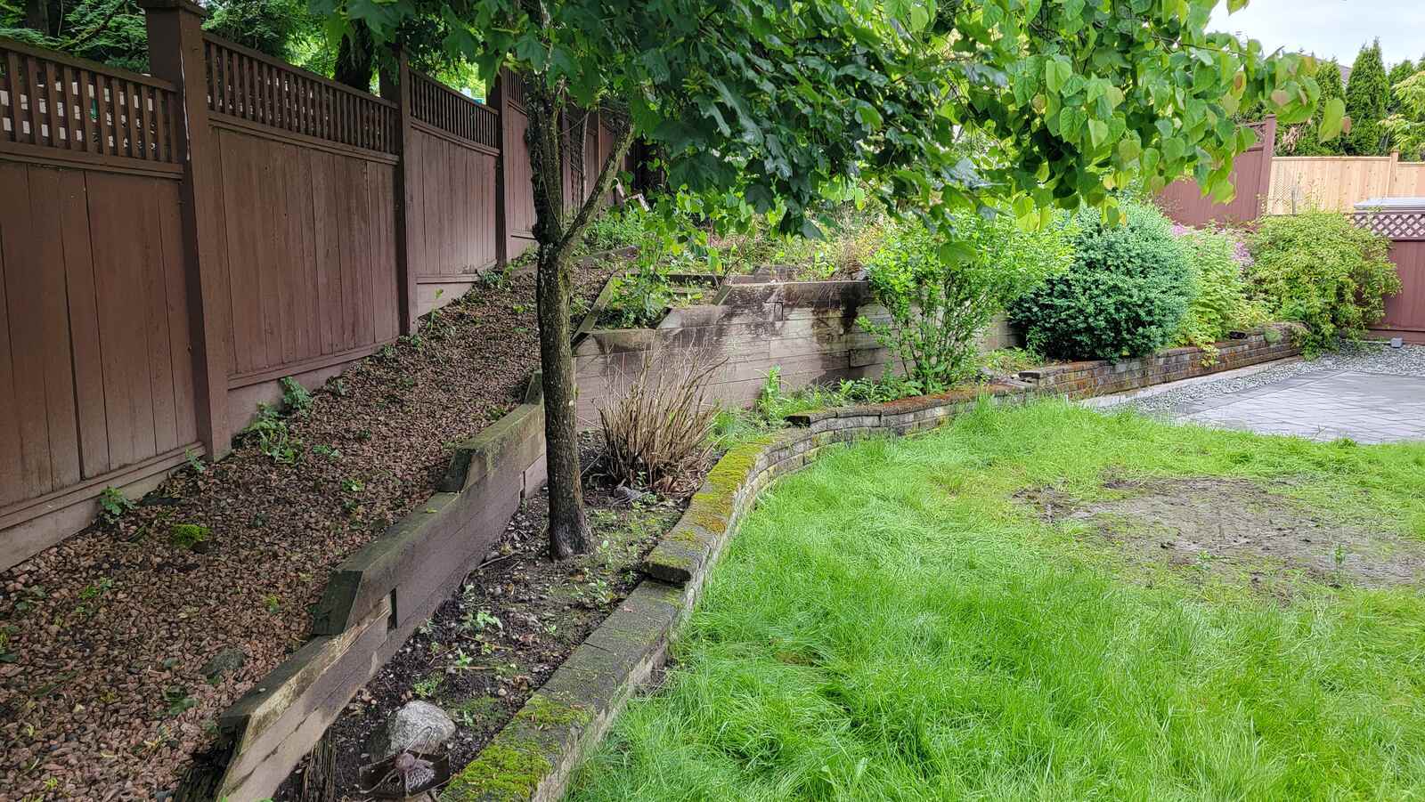 Side view of two-tier retaining wall installation by Back 40 Landscaping, Langley, BC