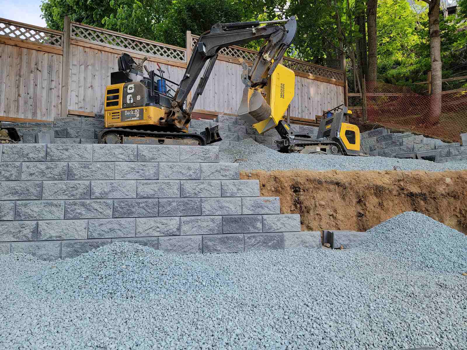 Equipment used by Back 40 Landscaping to build a retaining wall in Langley, BC