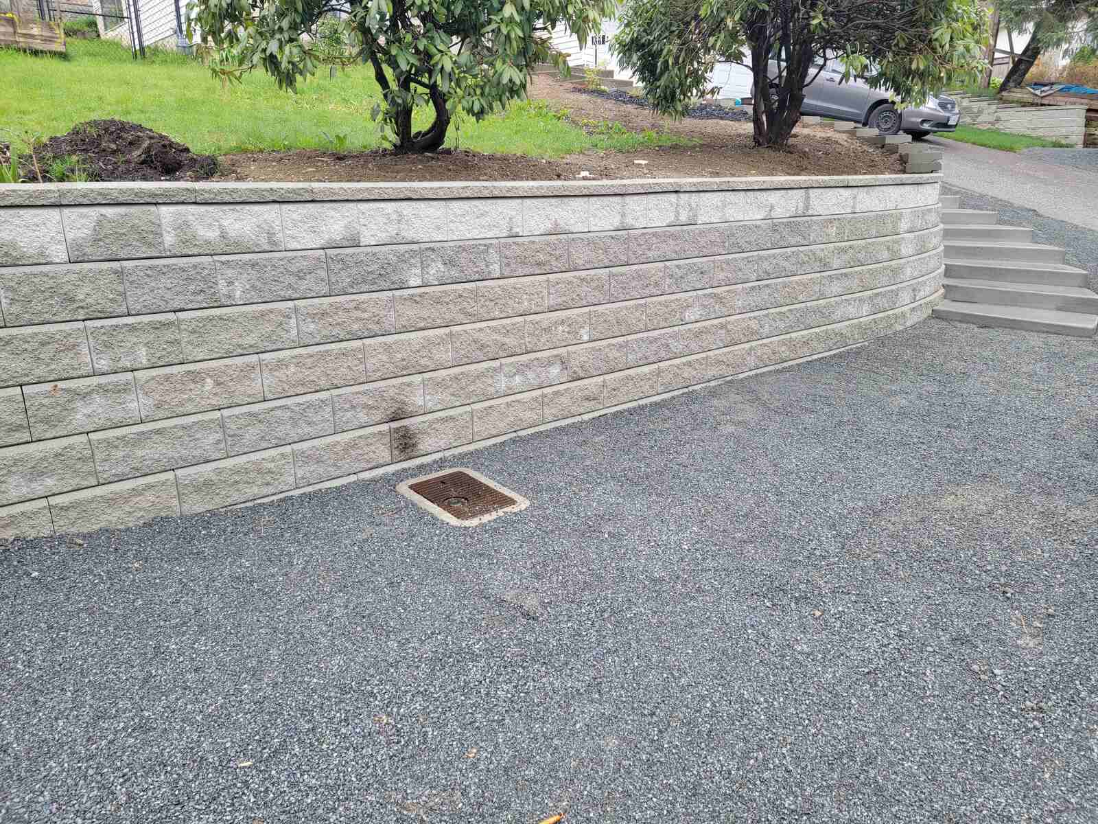 Close view of smooth gravel pathway beside retaining wall by Back 40 Landscaping in Mission, BC