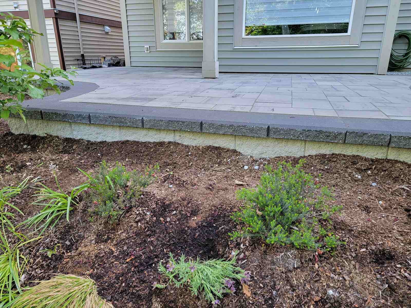 Elevated patio with a small landscaped garden by Back 40 Landscaping in Abbotsford, BC